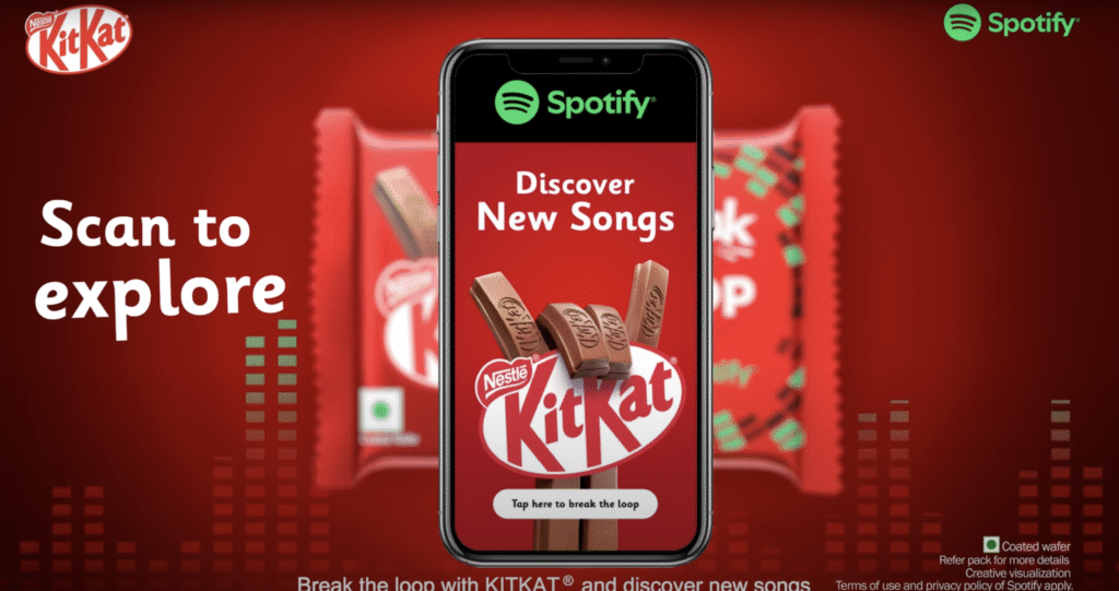 KitKat chocolate bar with Spotify partnership, phone screen showing music discovery promp