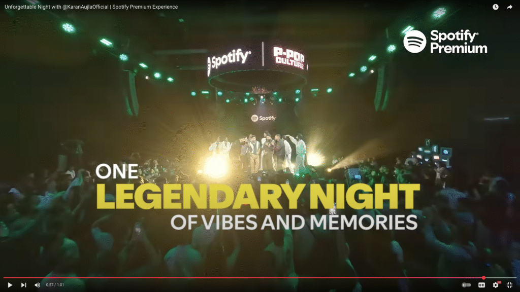 Excited crowd capturing a Spotify Premium live event with their phones, highlighting the exclusive fan experience.