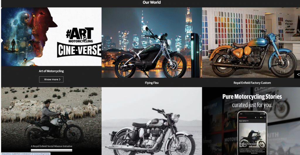 Royal Enfield website section ‘Our World’ displaying Hero images for ‘Art of Motorcycling Cine-Verse’, ‘Flying Flea’ electric bike charging, and a Factory Custom model.