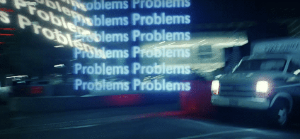 Close-up still from Claude campaign showing blurred text reading 'Problems Problems Problems' in motion, emphasising the campaign's focus on acknowledging overwhelming challenges"