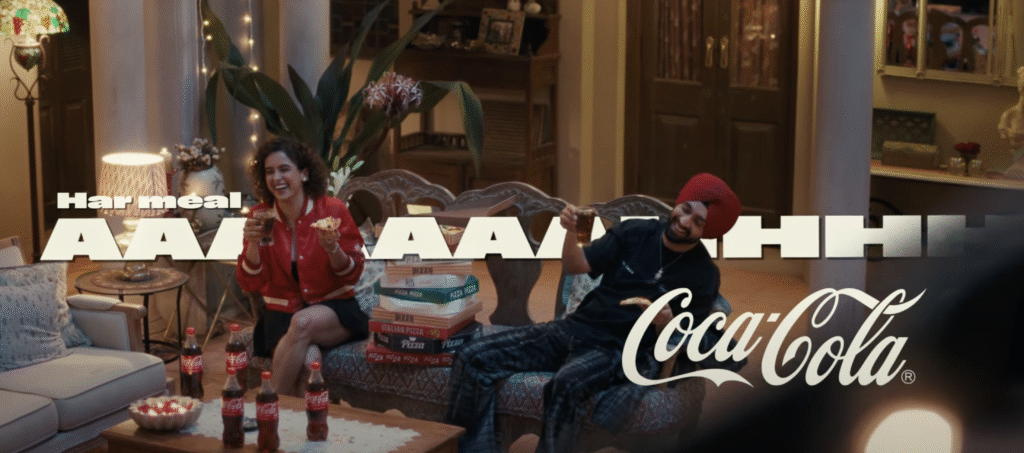 Diljit Dosanjh and Sanya Malhotra enjoy pizza and Coca-Cola with “Har meal Aaaahhh” branding